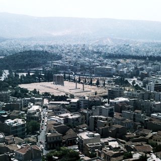 Ancient Agora in Athens, surrounded by modern city.