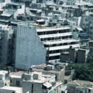 Urban cityscape with historic hilltop fortress.