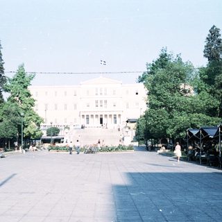 Neoclassical building in a spacious park area.