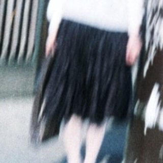 Child standing beside large beer kegs at Café Victoria.