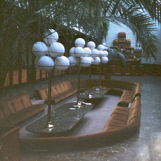 Luxurious indoor pool area with seating.