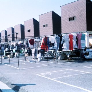 Outdoor clothing drying area with hanging garments.