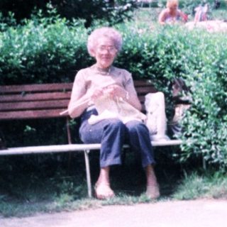 Person sitting alone on park bench.