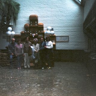 Group gathered around a vintage soda fountain.