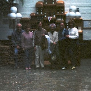 Group gathered around a vintage soda fountain.