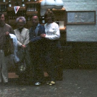 Group gathered around a vintage soda fountain.