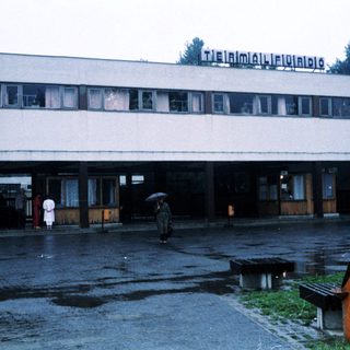 "Rainy day at a train station entrance."