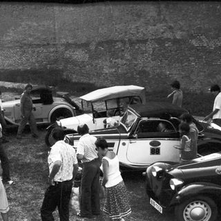 Vintage gathering near classic cars.
