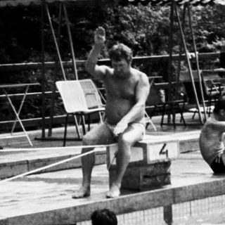 Water polo match in progress at an outdoor pool.