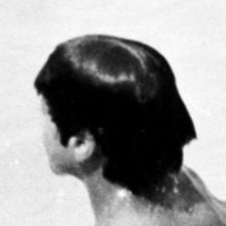 Two children swimming in shallow water.