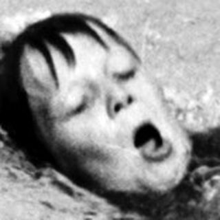 Person swimming underwater in pool.