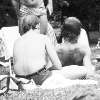 People relaxing outdoors in natural setting.