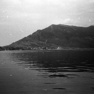 Mountain range reflected in calm lake water.