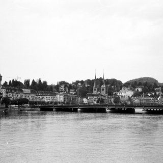 Historic European riverside town with bridges and church spires.