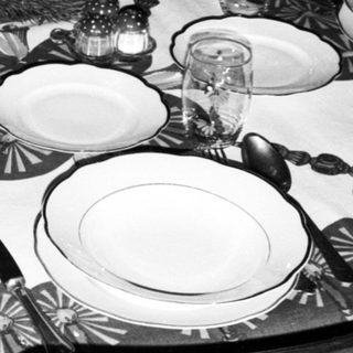 Elegant black-and-white holiday table setting with formal place settings.