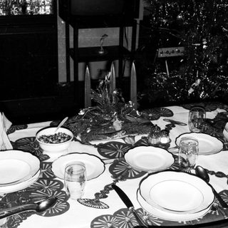 Elegant black-and-white holiday table setting with formal place settings.