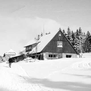 Snow-covered mountain lodge and ski resort buildings.