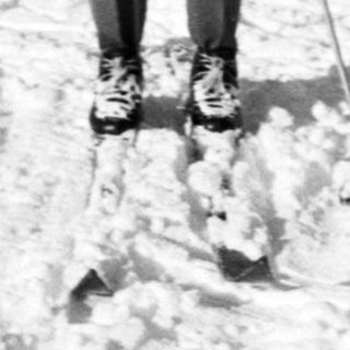 Person cross-country skiing on snow-covered trail.