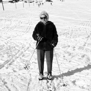 Person cross-country skiing on snow-covered trail.