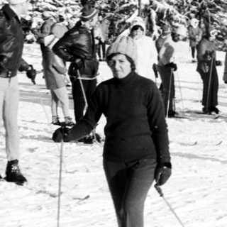 People skiing on snowy mountain slope.