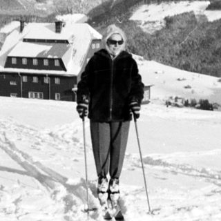 Person skiing on snowy mountain landscape.