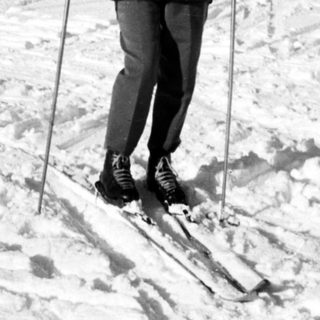 Person cross-country skiing in snowy landscape.