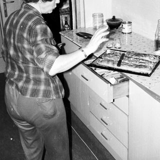 Person preparing food on stove in kitchen.