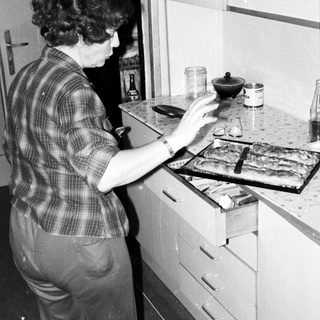 Person preparing food on stove in kitchen.