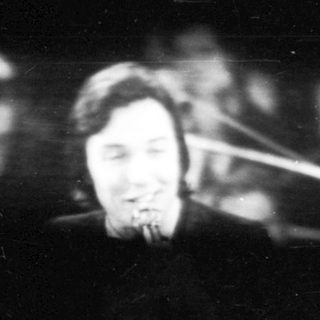 Blurred live musician performing on stage.