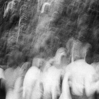 Blurred crowd in heavy rain.