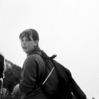 Group hiking outdoors on a cloudy day.