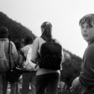 Group hiking outdoors on a cloudy day.