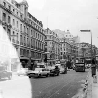 Busy mid-20th-century European city street scene.