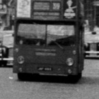 Busy mid-20th-century European city street scene.