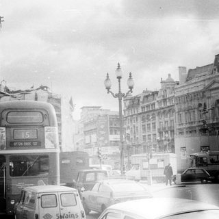 Classic London street scene with vintage double-decker buses.