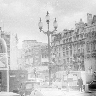 Classic London street scene with vintage double-decker buses.