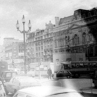 Classic London street scene with vintage double-decker buses.