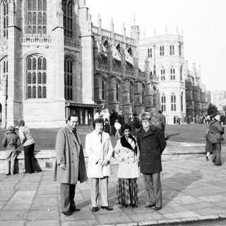 Historic castle exterior with group posing outside.