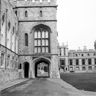 Historic stone castle courtyard with arched entrance.