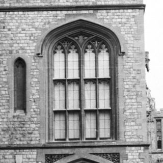Historic stone castle courtyard with arched entrance.