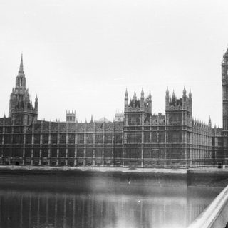Two men near Big Ben and Houses of Parliament.