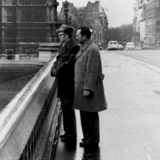 Two men near Big Ben and Houses of Parliament.