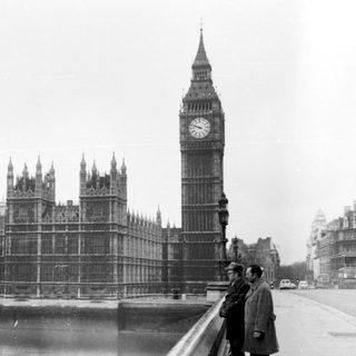Two men near Big Ben and Houses of Parliament.