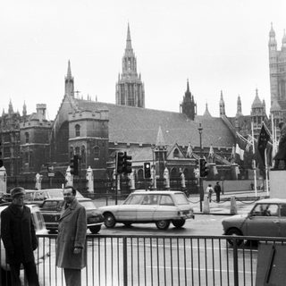 Historic London street scene with Parliament buildings.