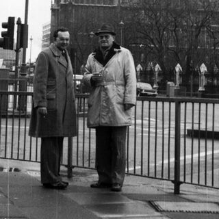 Two men standing near Big Ben.