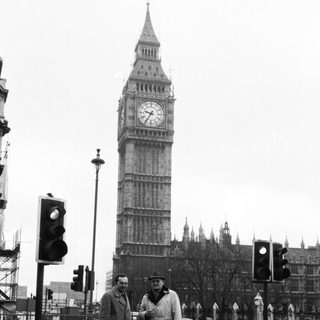 Two men standing near Big Ben.