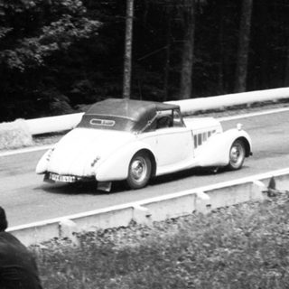 Classic race car on winding road race.
