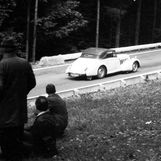 Classic race car on winding road race.