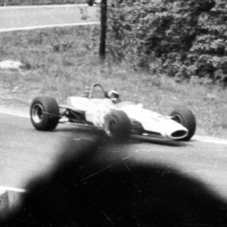 Classic race cars on a winding track.