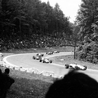 Classic race cars on a winding track.